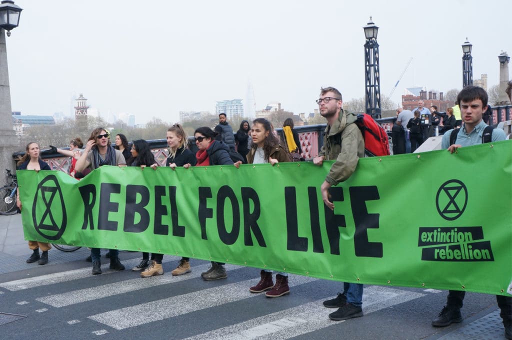 Extinction Rebellion XR goes on Rebellion. They occupied many places in Londoncut many roads in London. They have a banner with Rebel for Live. Published in The Green Bee: Eco-Journalism. Author Juanele Villanueva